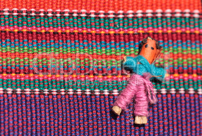 Macro of a handmade little textured Mexican cloth doll