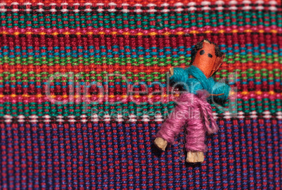 Macro of a handmade little textured Mexican cloth doll