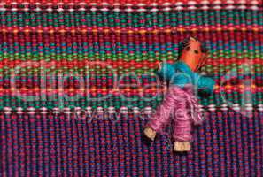 Macro of a handmade little textured Mexican cloth doll