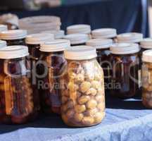 Jars of colorful olives grown and pickled