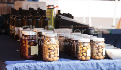 Jars of colorful olives grown and pickled