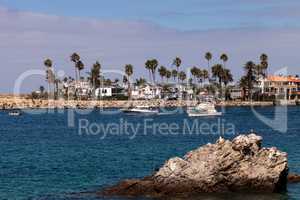 Sailboat and a motorboat leaving the harbor