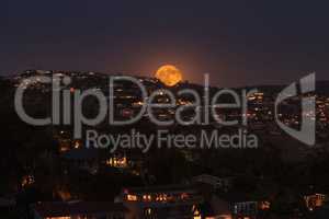 Moonrise of a full moon over the coastline of Laguna Beach
