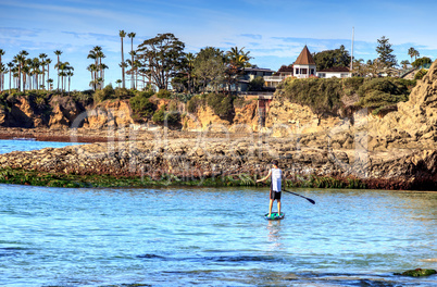 Paddleboarder on a surfboard on the ocean