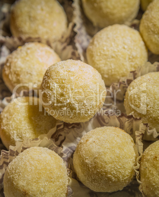 Round candies in coconut sprinkles