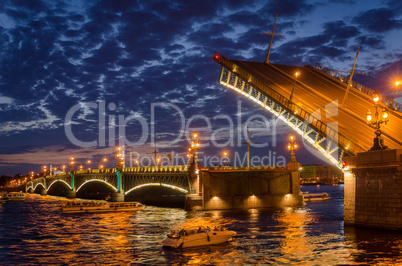 Night cityscape with river and bridge and ship in Saint-Petersbu