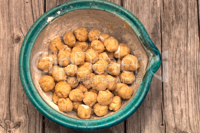 Bread dough balls rise in a bowl