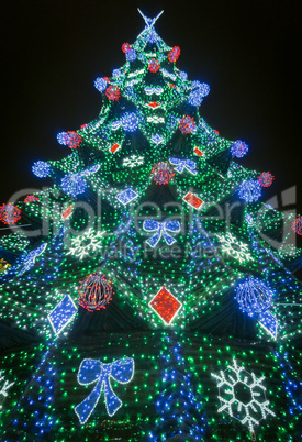 Colorful decorated fir with bright electric lights.