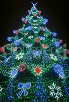 Colorful decorated fir with bright electric lights.