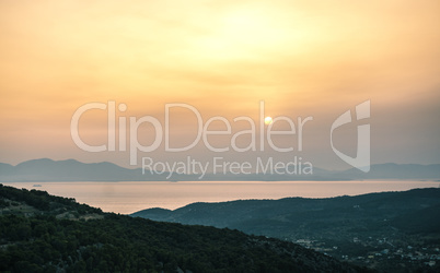 Sunrise view of mountains and sea on Aegina island, Greece.