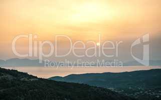 Sunrise view of mountains and sea on Aegina island, Greece.