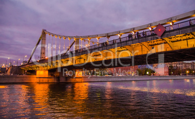 Moscow night landscape with river and bridge.