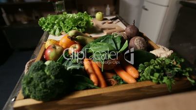 Set of fresh vegetables and fruits on wooden tray