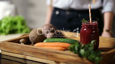 Healthy beet smoothie in mason jar on wooden tray