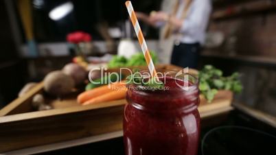 Jar of fresh beetroot smoothie with striped straw