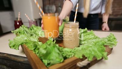 Woman serving tray with colorful smoothies