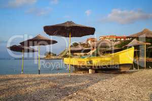 Straw beach umbrellas and rescue boat