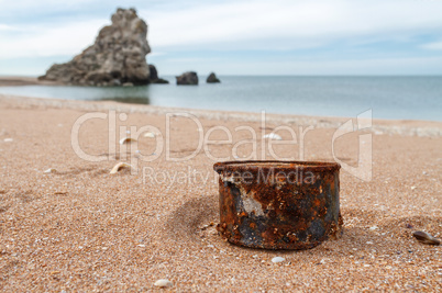 Rusty tin can on the beach