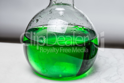 Green liquid in glass flask