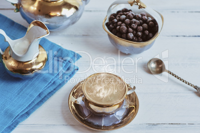Cup and saucer, black espresso coffee on a white wooden surface