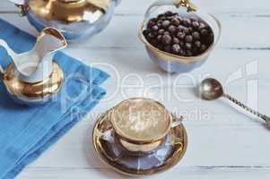 Cup and saucer, black espresso coffee on a white wooden surface