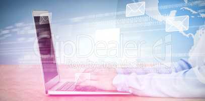 Composite image of cropped image of businesswoman using laptop