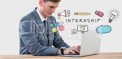 Composite image of businessman using laptop on desk