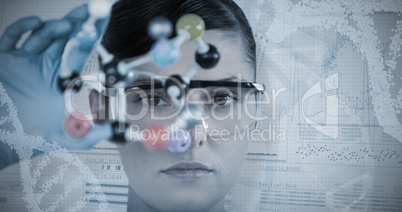 Composite image of portrait of female scientist holding molecular model