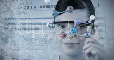 Composite image of portrait of scientist holding molecular model