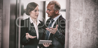 Businessman with colleague in elevator