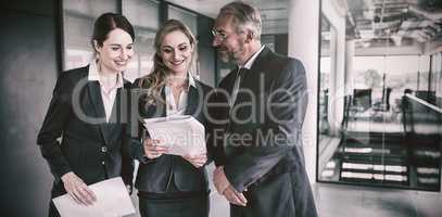 Happy businesspeople discussing over report
