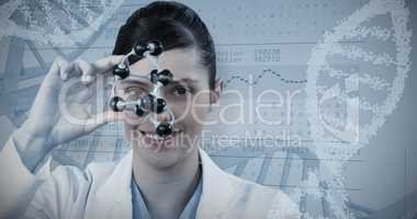 Composite image of portrait of female scientist holding molecular model