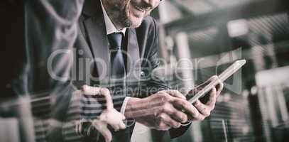 Businessman with colleague using digital tablet