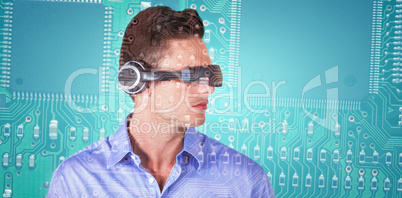 Composite image of handsome young man with virtual reality simulator