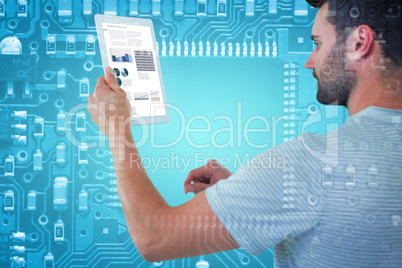 Composite image of man holding digital tablet