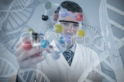 Composite image of portrait of scientist holding molecule structure