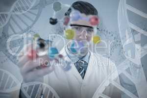 Composite image of portrait of scientist holding molecule structure