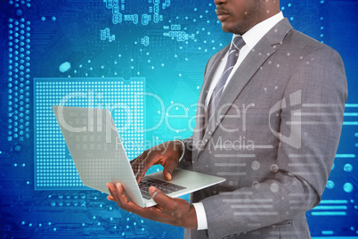 Composite image of midsection of businessman using laptop