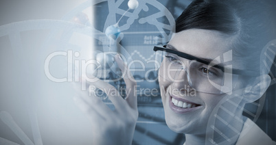 Composite image of female scientist holding molecular model