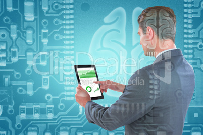 Composite image of businessman using tablet
