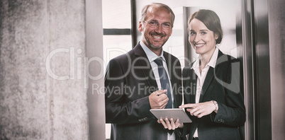 Smiling businessman with colleague in elevator