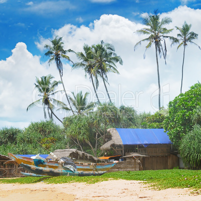 old fishing boats and huts on sandy beach