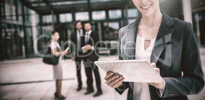 Portrait of businesswoman holding digital tablet