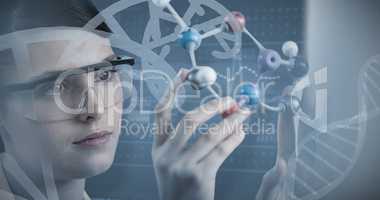 Composite image of close-up of scientist holding molecular model