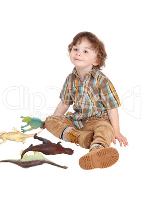 Smiling little boy with his toys.