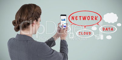 Composite image of businesswoman using mobile phone