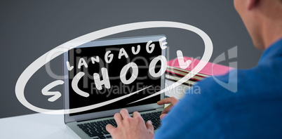 Composite image of man using laptop at desk