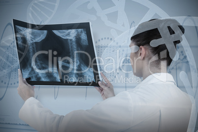 Composite image of female doctor checking x-ray report