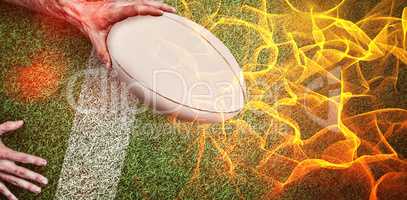 Composite image of a man holding rugby ball