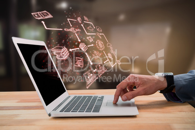 Composite image of businessman scrolling laptop mouse
